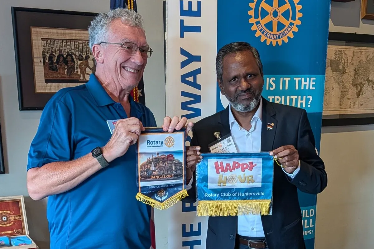 Flag exchange with the Huntersville Happy Hour Rotary Club